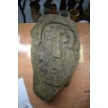 A MEDIEVAL STONE HEAD possibly from a tomb or gargoyle.