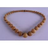 A LATE 19TH/20TH CENTURY CARVED BLOND RHINOCEROS HORN NECKLACE of graduated form. 38 grams. 36 cm