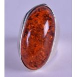 A LARGE SILVER AND AMBER RING.