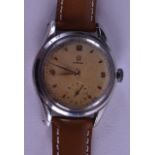 A VINTAGE OMEGA WRISTWATCH with gilt toned dial. 3 cm diameter.