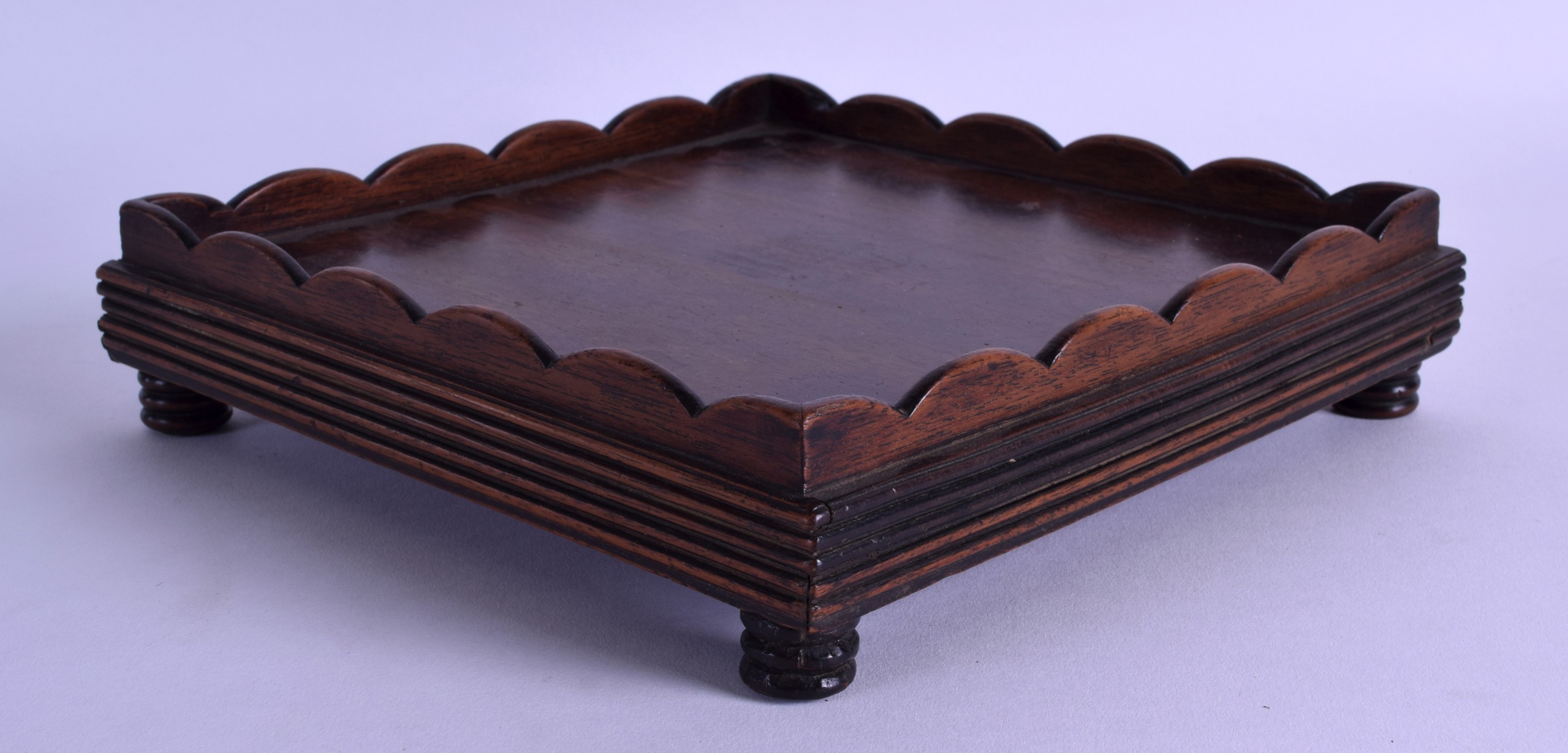 A 19TH CENTURY CHINESE CARVED HARDWOOD SQUARE FORM STAND with raised lip. 20.5 cm square.