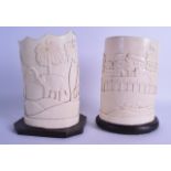 A PAIR OF EARLY 20TH CENTURY AFRICAN CARVED IVORY TUSK VASES converted to lamps, carved with