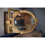 A NEO CLASSICAL GILTWOOD MIRROR of scrolling form. 64 cm x 101 cm.