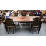 A LARGE OAK DININNG TABLE, together with seven matching chairs.7 ft 9ins wide.