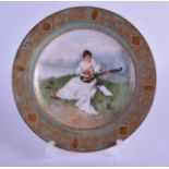 A SMALL EARLY 20TH CENTURY VIENNA PORCELAIN PLATE painted with a female musician within a landscape.