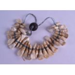 AN UNUSUAL TRIBAL CARVED TOOTH HUNTERS NECKLACE. 20 cm long overall.