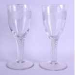 A PAIR OF 18TH/19TH CENTURY ENGRAVED GLASSES engraved with acorn and vine leaves, upon cylindrical