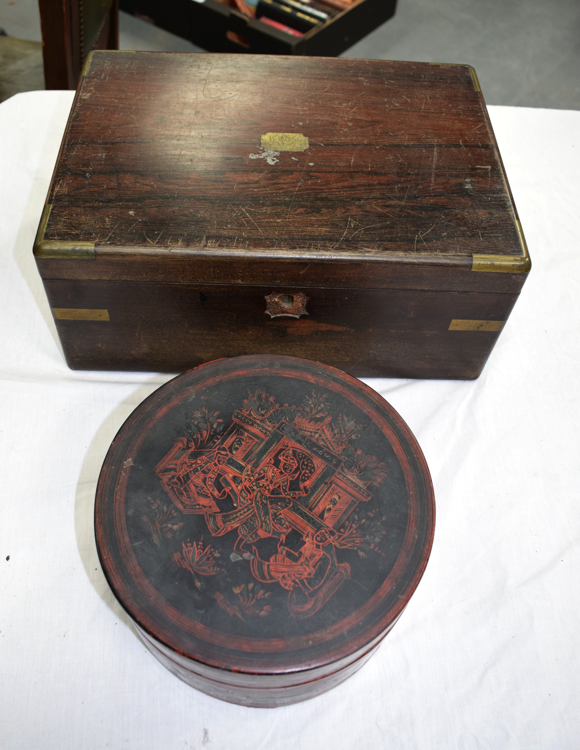 AN EASTERN LACQUERED CIRCULAR BOX AND COVER together with a Victorian rosewood brass bound writing