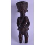 A SMALL AFRICAN TRIBAL CARVED WOOD FERTILITY FIGURE modelled as a child breast feeding. 18 cm high.