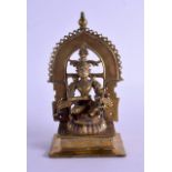 AN 18TH CENTURY INDIAN BRONZE FIGURE OF A BUDDHISTIC GOD with ruby inset eyes, upon a square plinth.