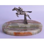 AN ART DECO HORSE RACING CARVE ONYX DESK with a jockey jumping a hurdle. 23 cm wide.