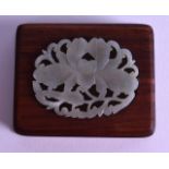 A 19TH CENTURY CHINESE JADE AND HARDWOOD SCROLL WEIGHT of rectangular form, inset with a floral