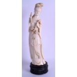 A LARGE EARLY 20TH CENTURY CHINESE CARVED IVORY FIGURE OF A FEMALE modelled holding a floral