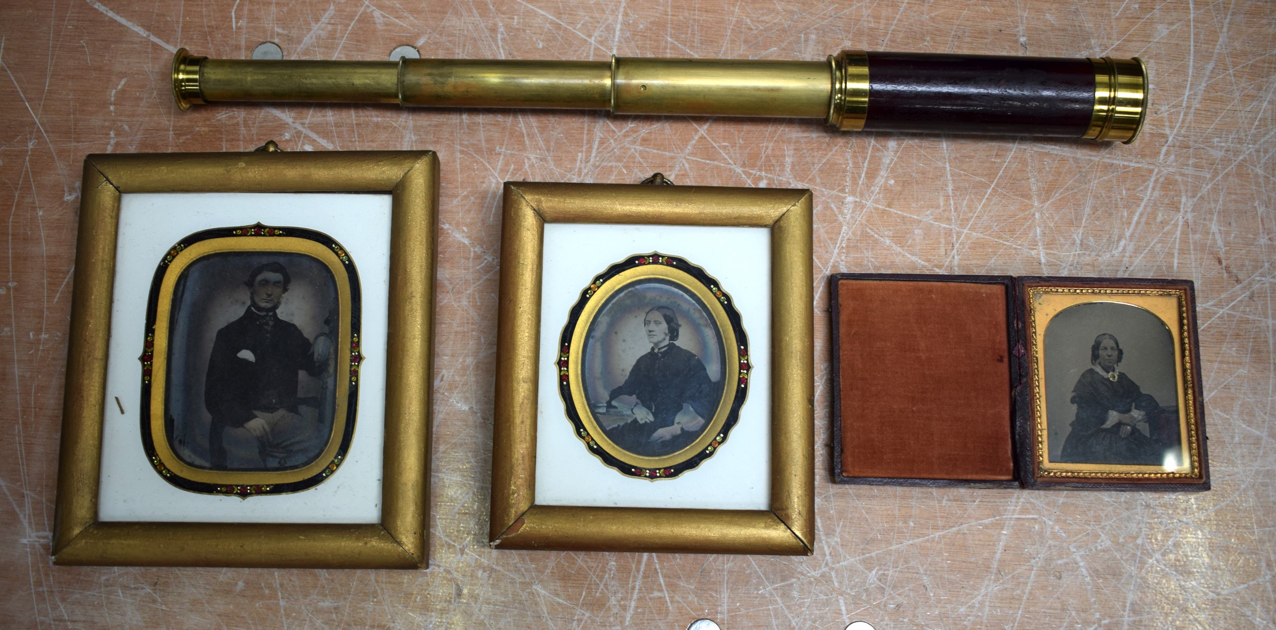 A 19TH CENTURY THREE DRAWER BRASS TELESCOPE together with three cased daguerreotype. (4)