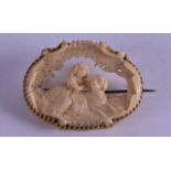 A FINE ANTIQUE CARVED IVORY BAVARIAN BROOCH decorated with a female and a hound. 4.25 cm wide.