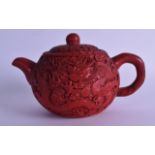 A RARE CHINESE QING DYNASTY CINNABAR LACQUER OVERLAID YIXING POTTERY TEAPOT AND COVER decorated with