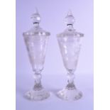 A MATCHED PAIR OF 19TH CENTURY BOHEMIAN CLEAR GLASS GOBLETS AND COVERS decorated with stag roaming