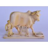 A 19TH CENTURY INDIAN CARVED IVORY FIGURAL GROUP depicting two cows & an attendant upon a