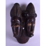 AN EARLY 20TH CENTURY AFRICAN TRIBAL CARVED WOOD DOUBLE MASK with polychromed decoration. 15 cm x 28