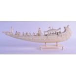 A LARGE 19TH CENTURY INDIAN CARVED IVORY BOAT modelled with various attendants. 38.5 cm wide.