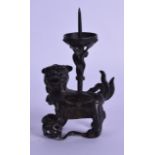A CHINESE LATE MING DYNASTY BRONZE PRICKET CANDLESTICK in the form of a buddhistic lion. 7 cm x 13.5