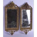 A PAIR OF LATE 19TH CENTURY EUROPEAN GILT METAL MIRRORS decorated with acanthus and classical mask