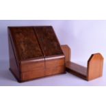 AN EDWARDIAN CARVED WALNUT STATIONARY DESK CABINET together with a similar associated sliding book