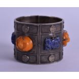 AN EARLY 20TH CENTURY CHINESE EXPORT SILVER LAPIS LAZULI AND AMBER BANGLE decorated with shou