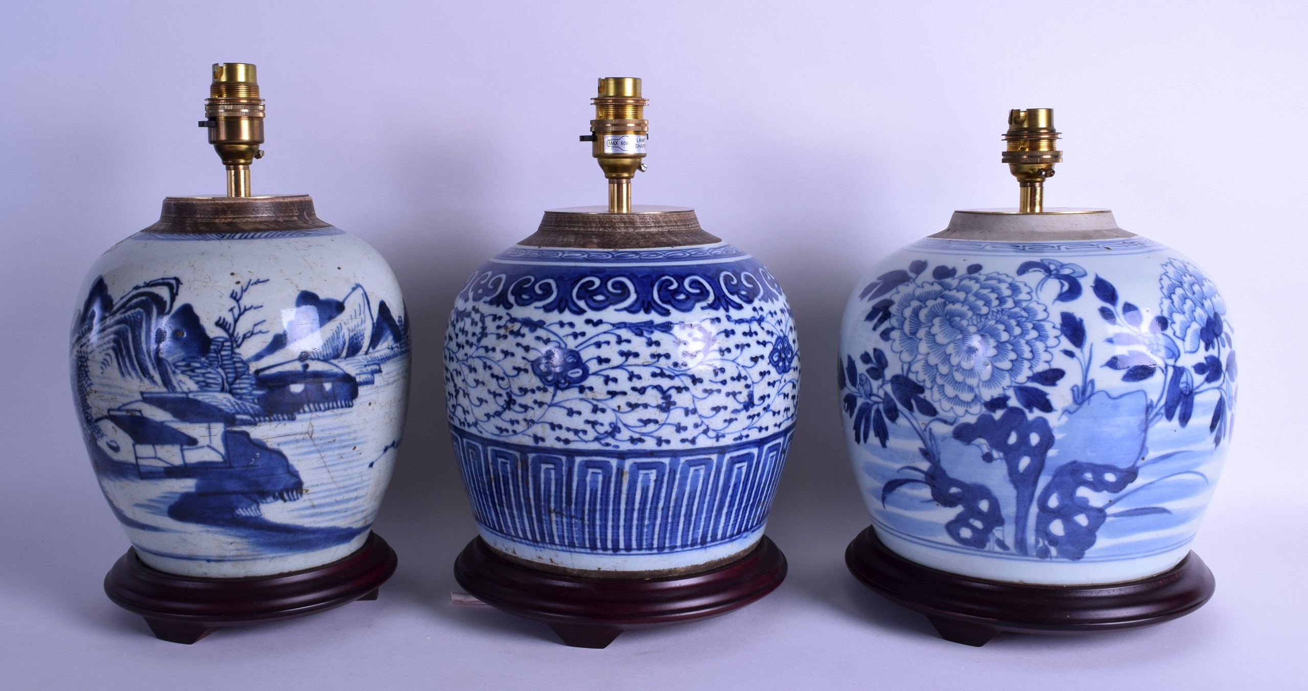 A SET OF THREE 18TH/19TH CENTURY CHINESE BLUE AND WHITE GINGER JARS converted to lamps. Largest