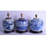 A SET OF THREE 18TH/19TH CENTURY CHINESE BLUE AND WHITE GINGER JARS converted to lamps. Largest