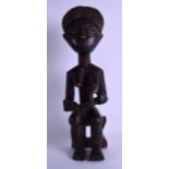 AN AFRICAN CARVED TRIBAL WOODEN FERTILITY FIGURE modelled with her breasts exposed. 40 cm high.