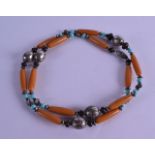 AN EARLY 20TH CENTURY EASTERN CARVED AMBER TURQUOISE AND WHITE METAL NECKLACE.