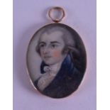 AN EARLY 19TH CENTURY GOLD MOUNTED PAINTED IVORY PORTRAIT MINIATURE depicting a male wearing a