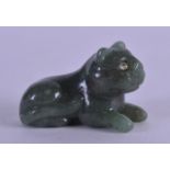 A SMALL EARLY 20TH CENTURY CONTINENTAL CARVED JADE CAT inset with diamond eyes. 5 cm wide.
