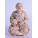 A 17/18TH CENTURY INDIAN CARVED MARBLE FIGURE OF A SEATED BUDDHISTIC MALE Ming, modelled holding