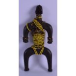 AN AFRICAN CARVED HARDWOOD FIGURE with bead work overlay. 30 cm high.