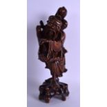 A 19TH CENTURY CHINESE CARVED HARDWOOD FIGURE OF A MALE modelled holding a floral sprig, upon a