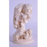 A FINE 19TH CENTURY JAPANESE MEIJI PERIOD CARVED IVORY OKIMONO modelled as a tiger holding aloft a