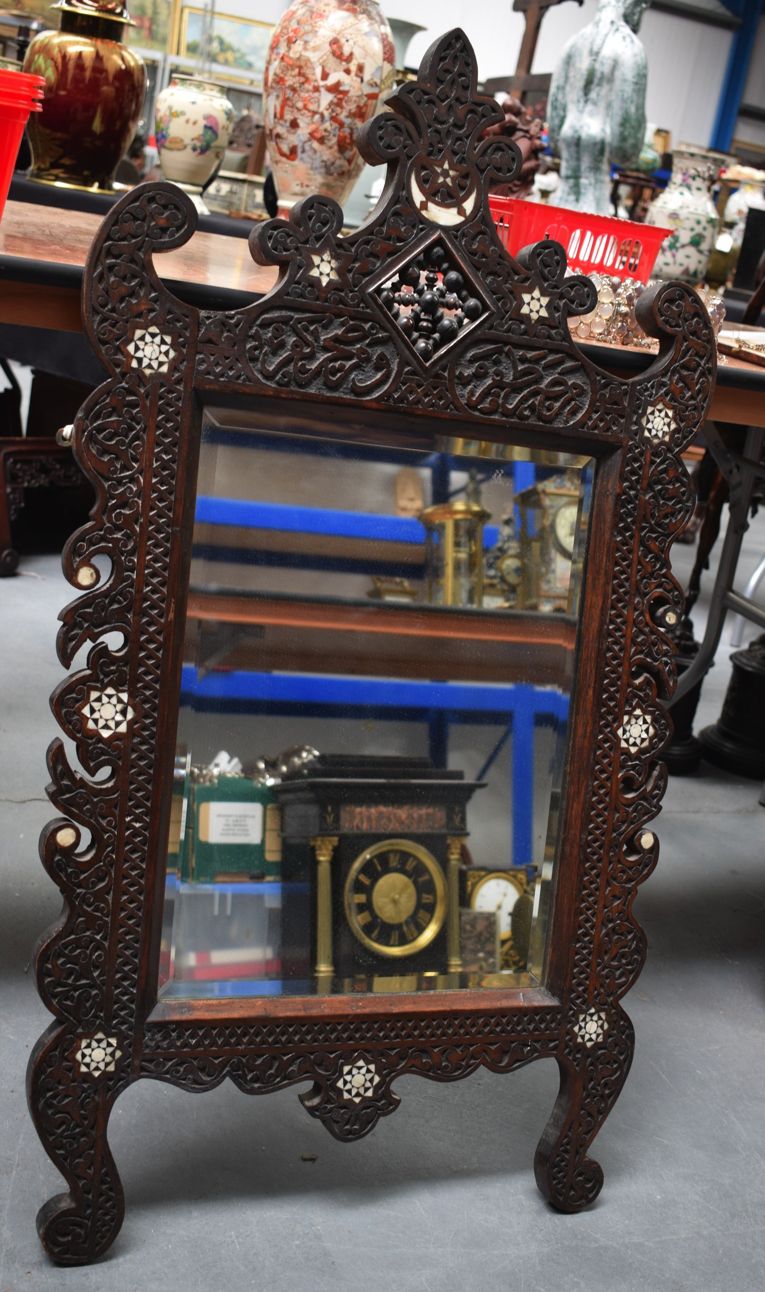 A LARGE LIBERTY~S TYPE HARWOOD SHELL INLAID MIRROR carved with calligraphy. 56 cm x 102 cm. Good