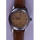 A VINTAGE OMEGA WRISTWATCH with gilt toned dial. 3 cm diameter. Tarnishing, running