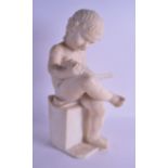 A 19TH CENTURY ITALIAN CARVED ALABASTER FIGURE OF A SEATED BOY modelled reading a book upon a square