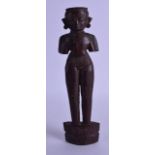 A 19TH CENTURY SOUTH EAST ASIAN CARVED WOODEN FIGURE with incised features. 23 cm high. Good