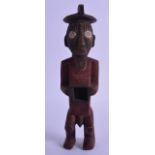 AN AFRICAN POLYCHROMED FERTILITY FIGURE modelled as a male with an open stomach. 22 cm high. Good