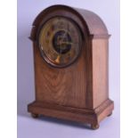 A LATE VICTORIAN/EDWARDIAN MANTEL CLOCK with pierced brass mounts to the dial. 34 cm x 23 cm.