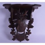 A LATE 19TH CENTURY BAVARIAN BLACK FOREST CARVED WOOD BRACKET with stags head mounts. 26 cm x 29