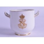 A LATE 19TH CENTURY SEVRES TWIN HANDLED PORCELAIN CUP with gilded emblems. 8.25 cm x 5.25 cm.