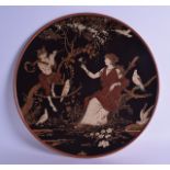 A LOVELY METTLACH POTTERY CHARGER by H Schmidt, painted with pan and a female surrounded by birds
