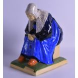 A RARE LARGE EARLY 20TH CENTURY FRENCH QUIMPER POTTERY FIGURE OF A FEMALE modelled bent over upon