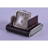 A RARE DUNHILL SILVER 'LA CAPTIVE' LEATHER BOUND MINIATURE TRAVELLING CLOCK with green stone mounts.