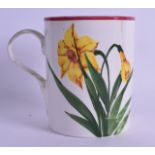 A LARGE SCOTTISH WEYMSS POTTERY MUG painted with daffodils. 14.5 cm high.